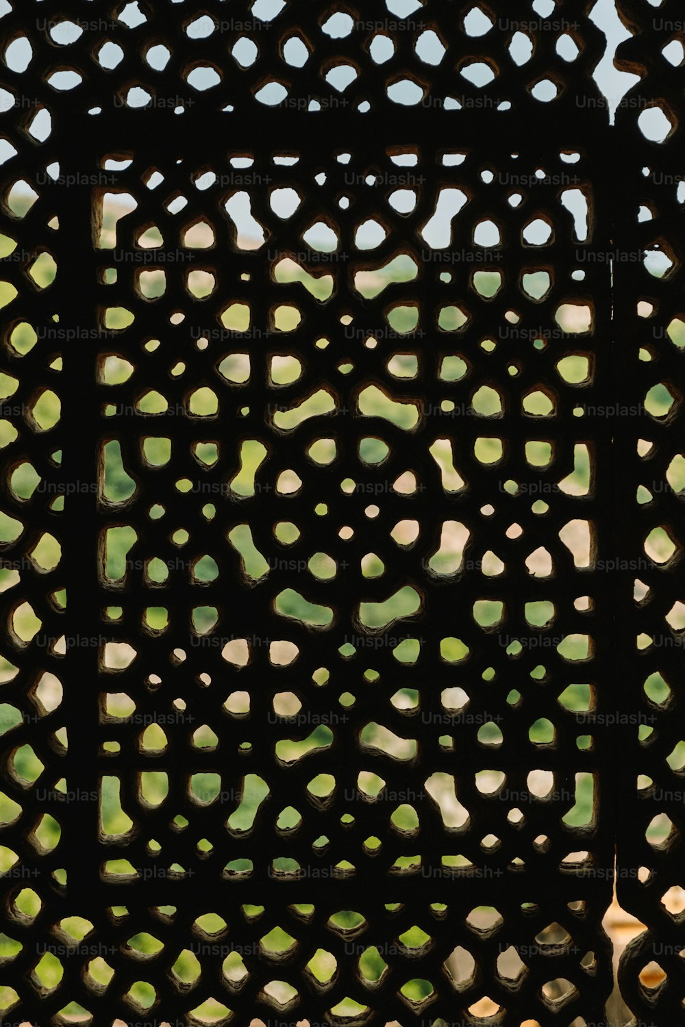 a close up of a metal grate with holes in it