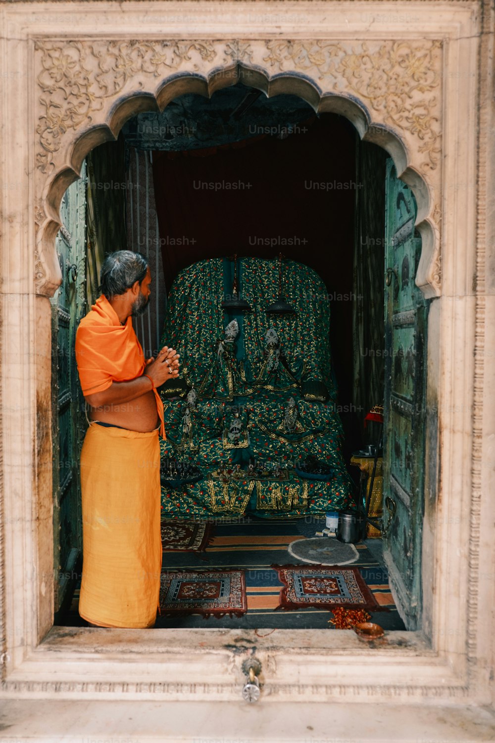 a woman standing in a doorway looking at her cell phone