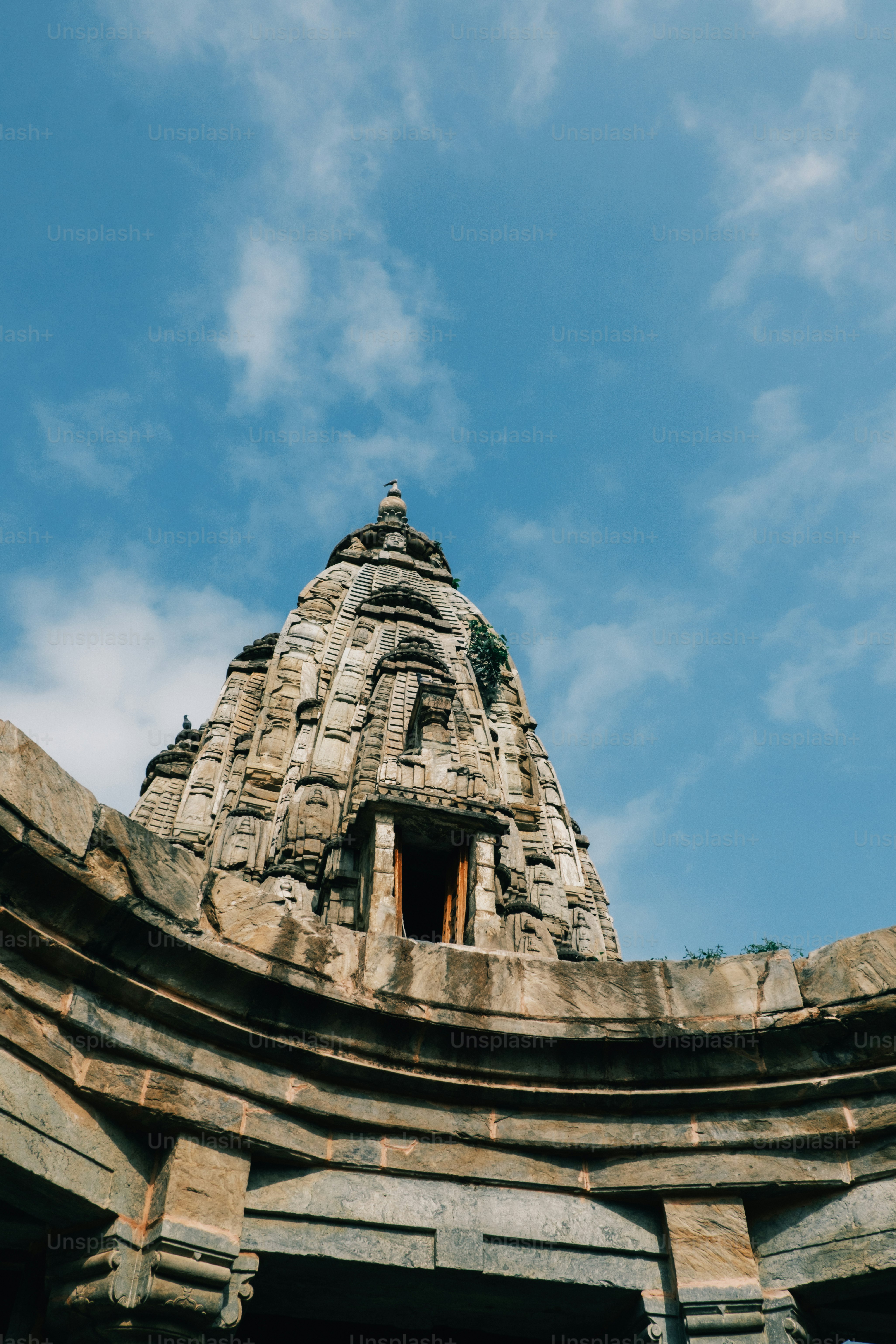 a very tall tower with a clock on it's side