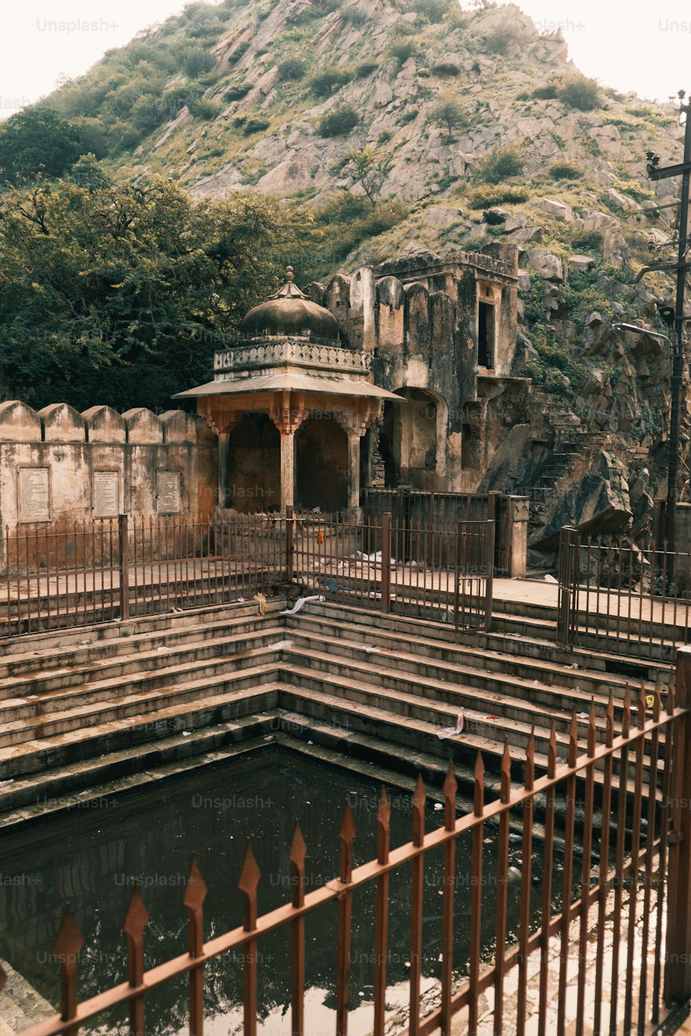 an old building with a fountain in the middle of it