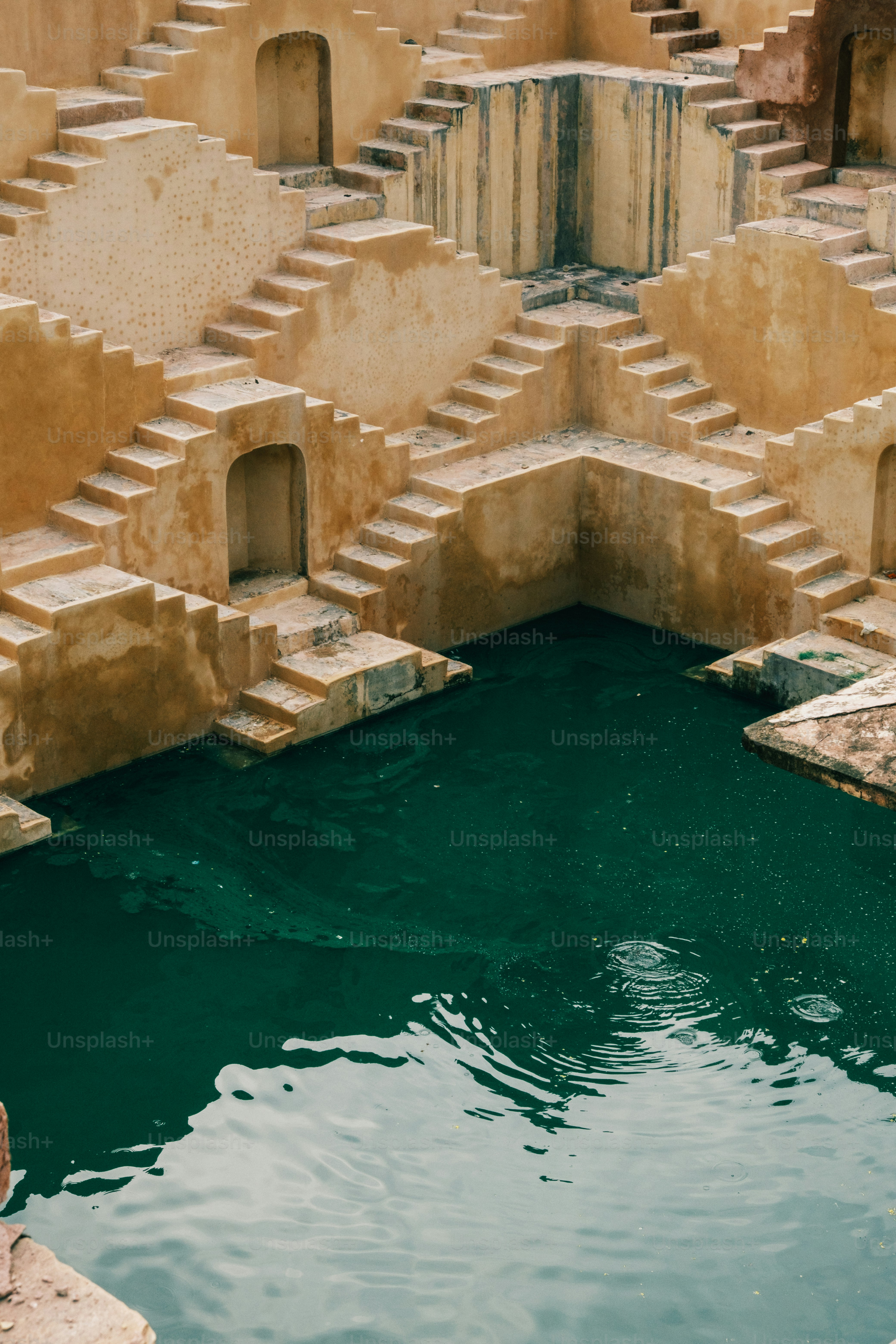 a man standing next to a pool of water