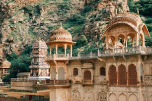 a couple of buildings that are next to a mountain