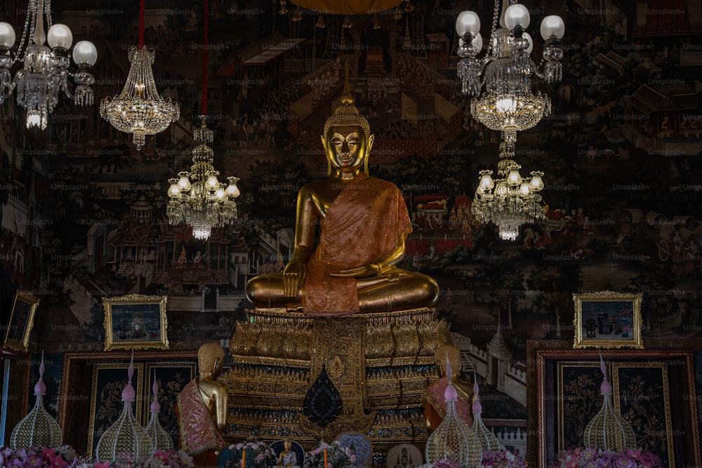 a golden buddha statue sitting on top of a wooden table