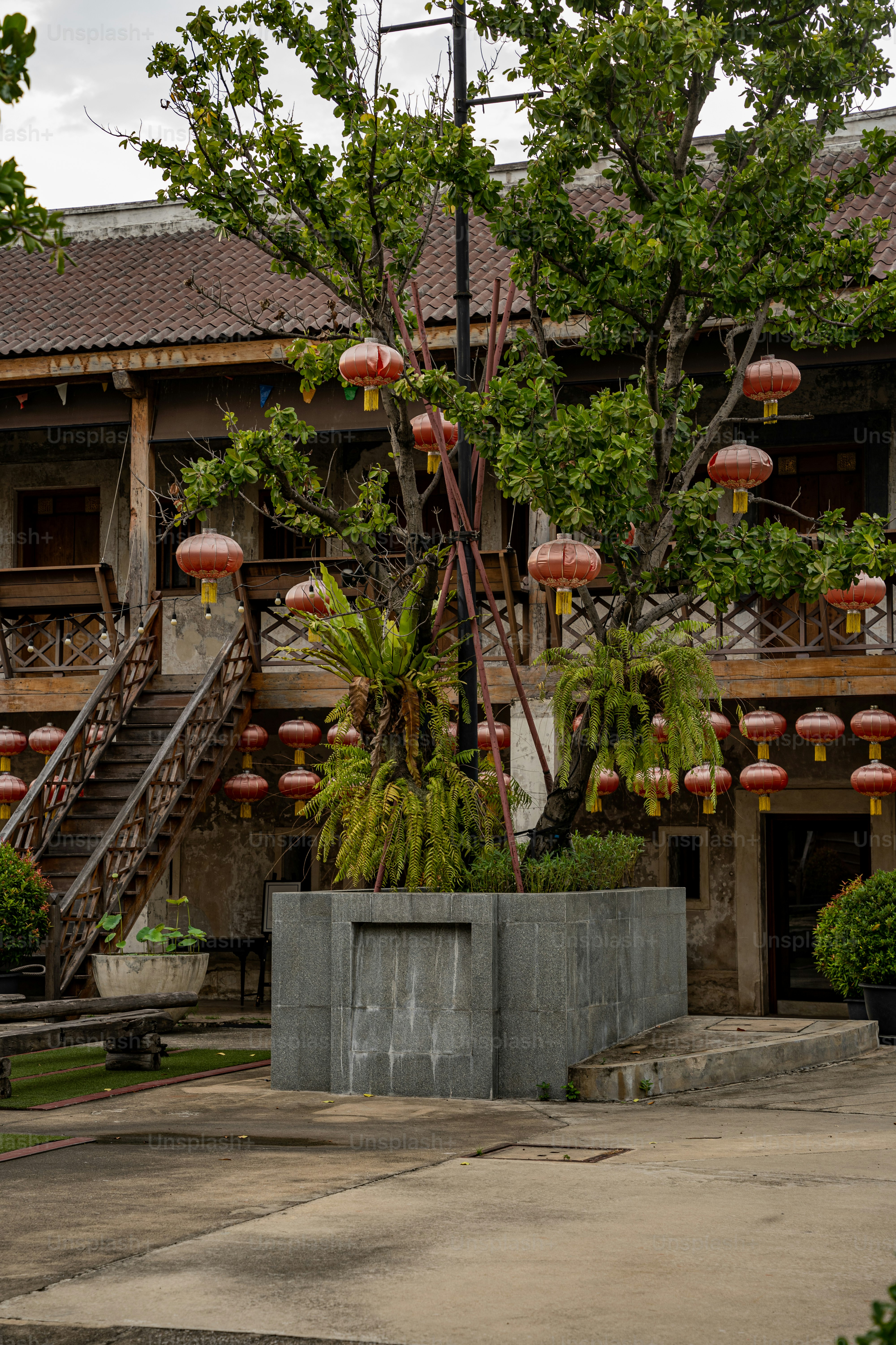 a building with a bunch of red lanterns hanging from it's roof