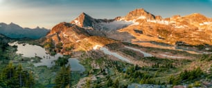 a mountain range with a lake in the foreground