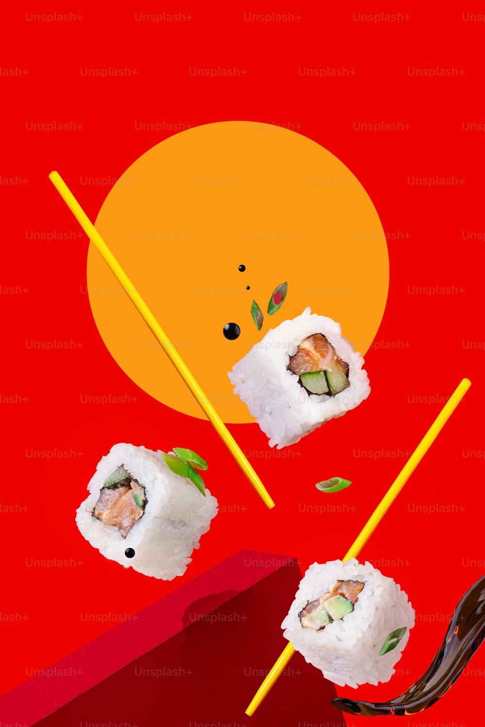 a red background with sushi and chopsticks