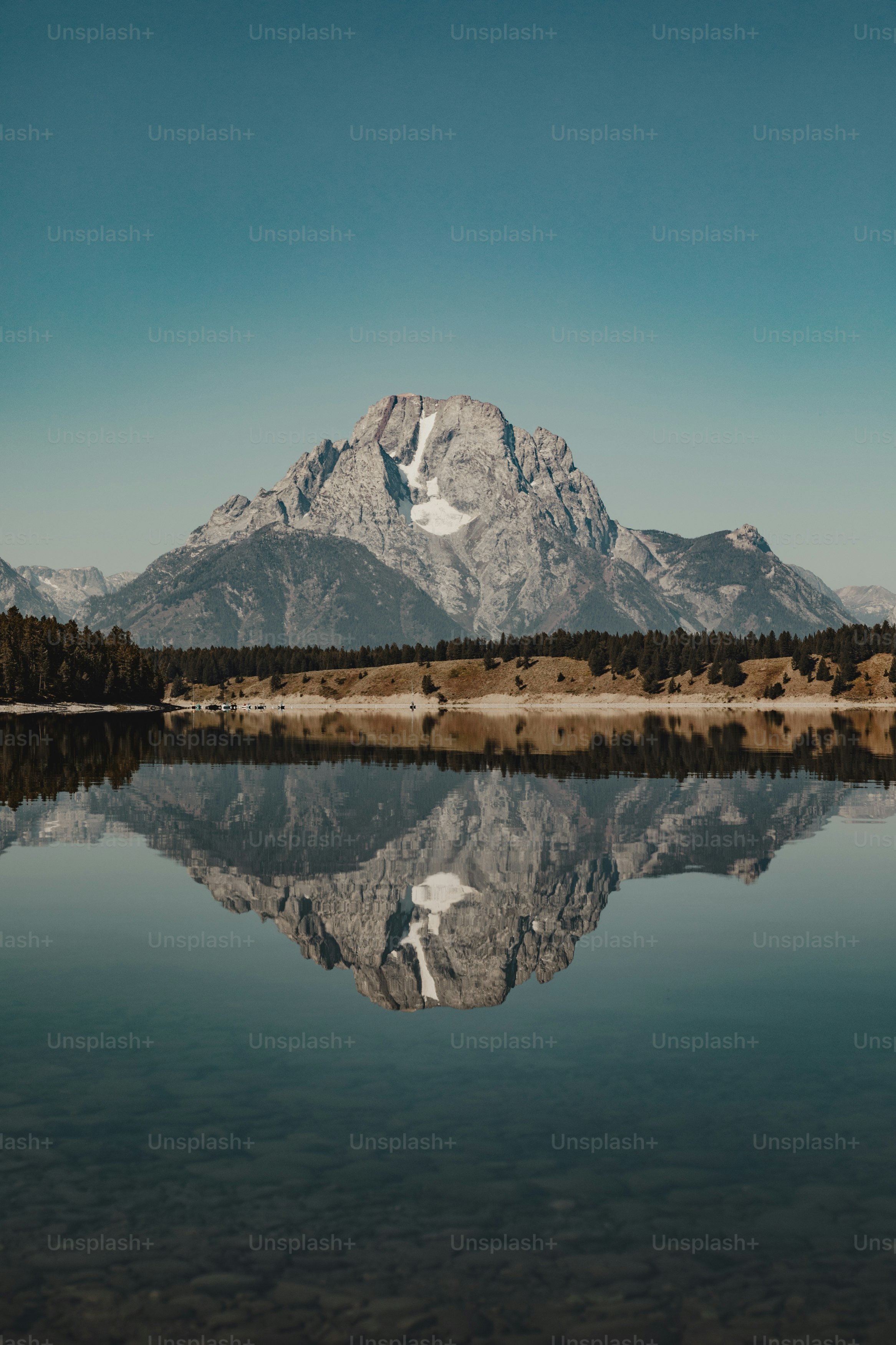 a mountain is reflected in the still water of a lake