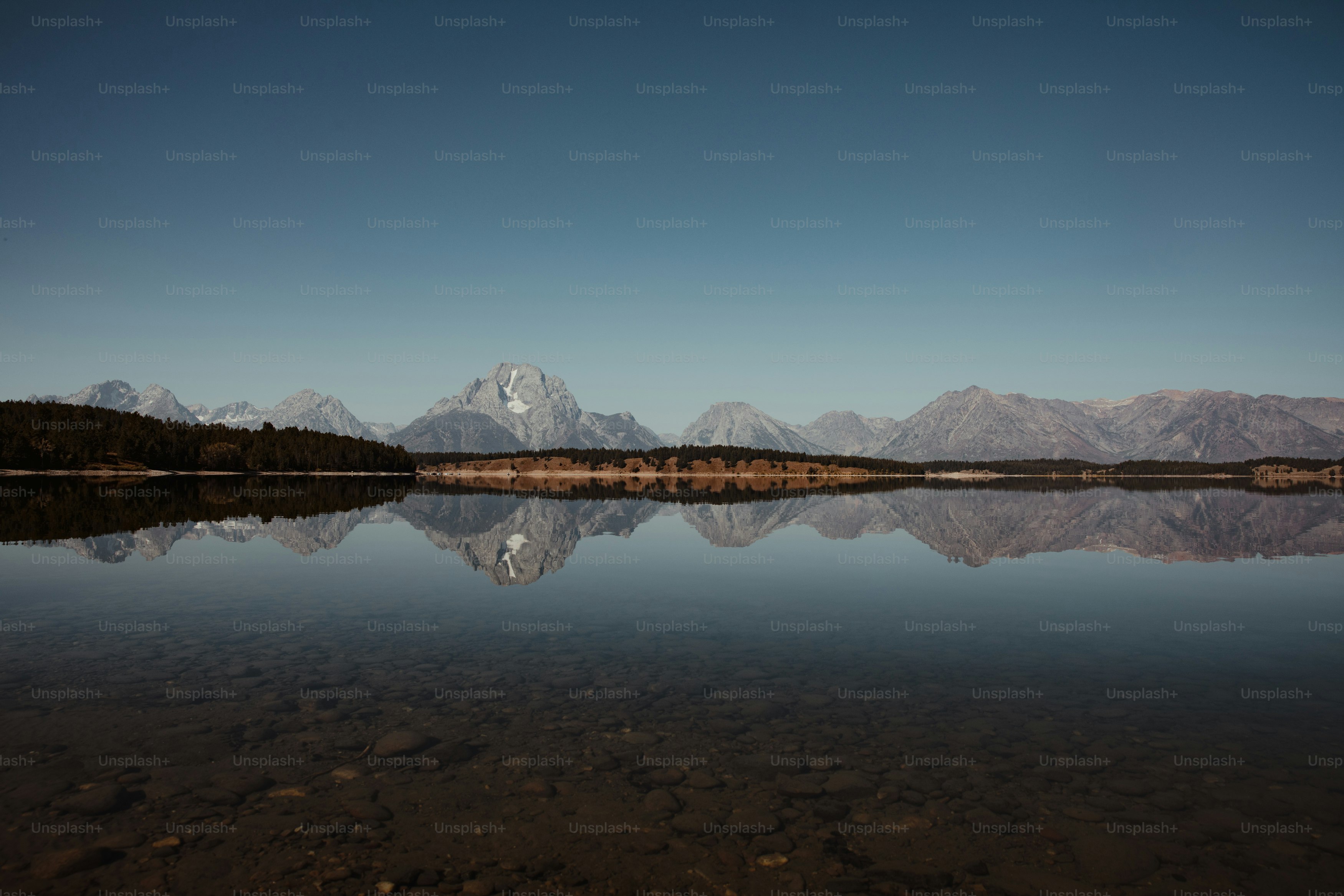 a large body of water with mountains in the background