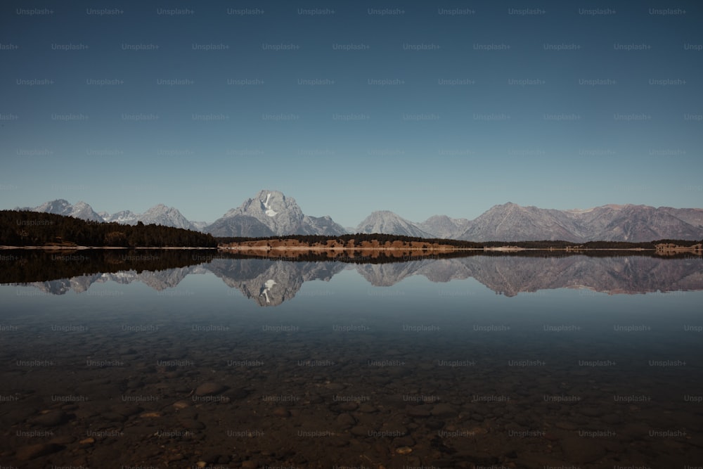 a large body of water with mountains in the background