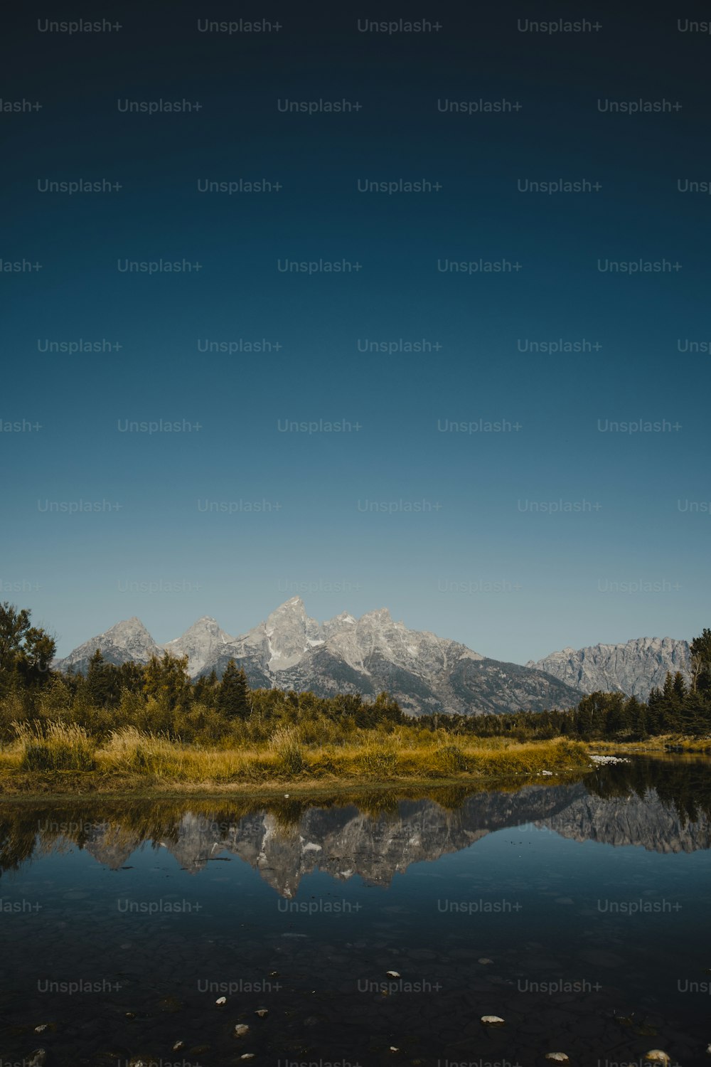 a large body of water with a mountain in the background