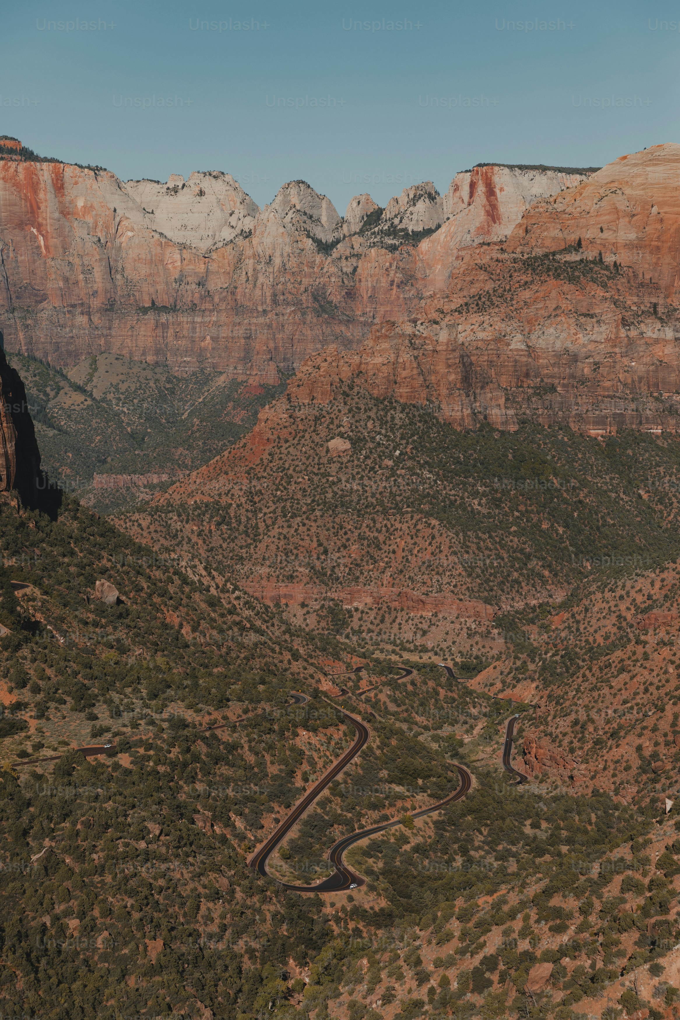 a scenic view of a mountain with a winding road
