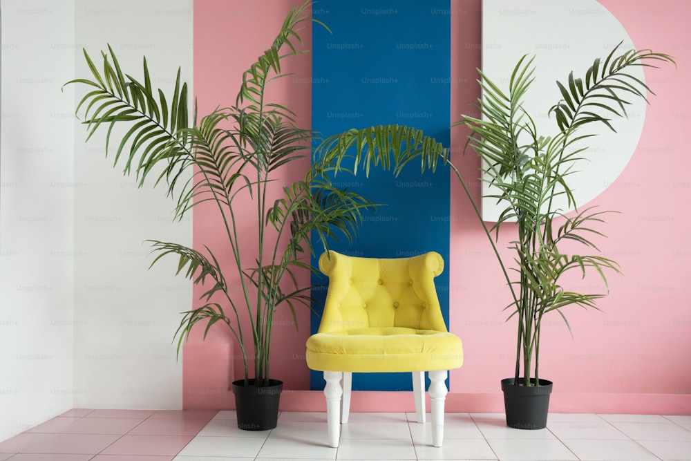 a yellow chair sitting in front of a pink and blue wall