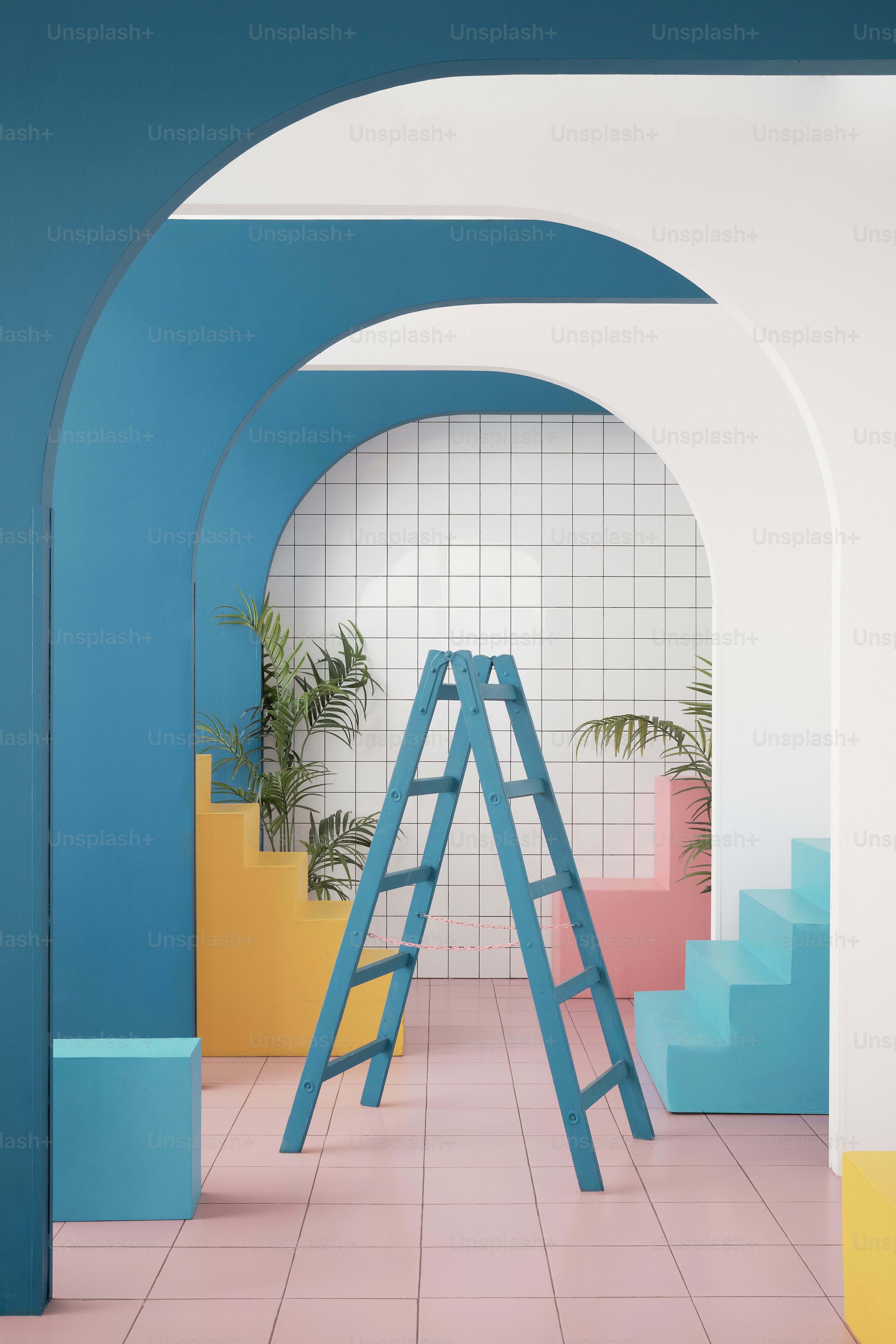 a room with a ladder, potted plant, and tiled walls