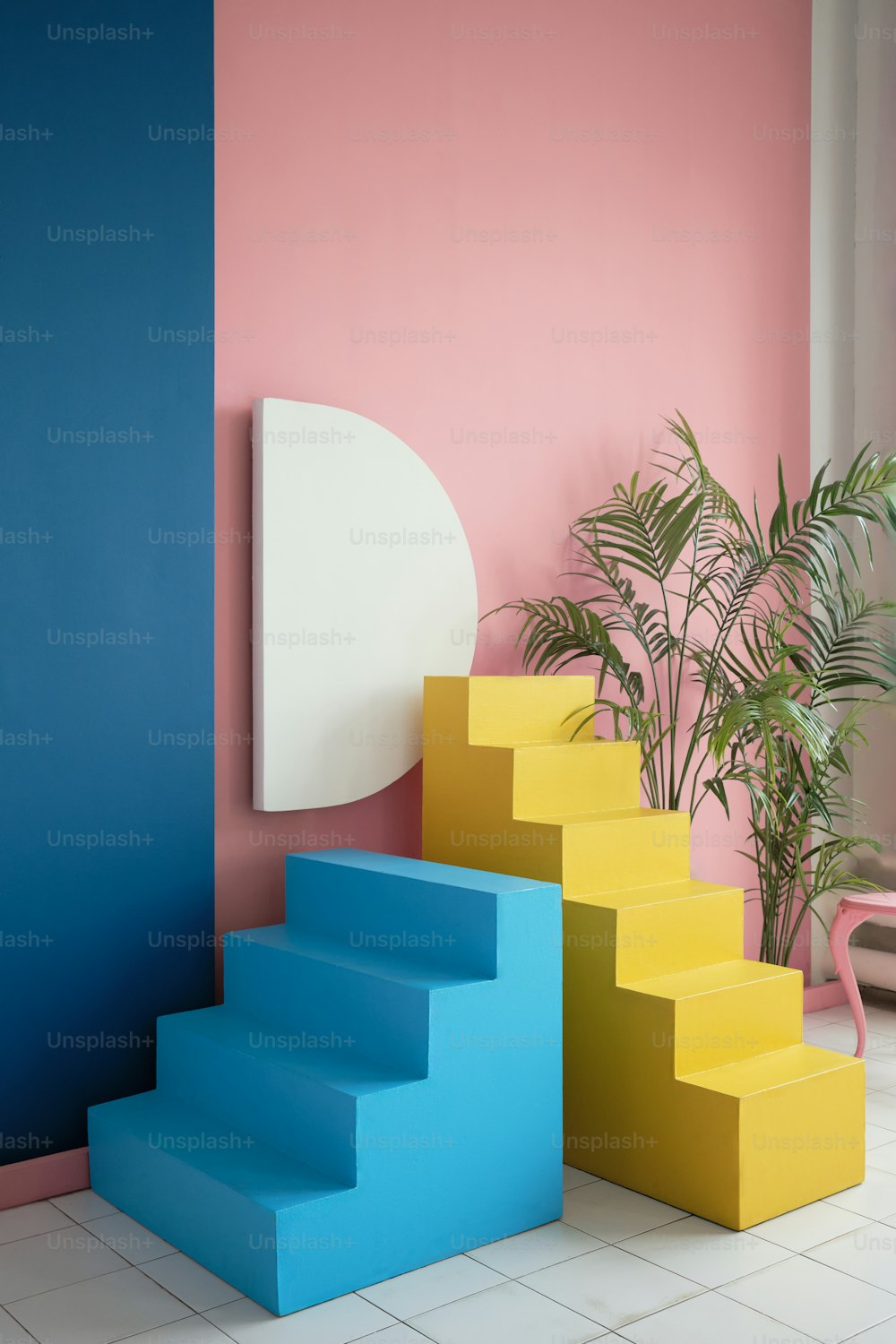 a set of colorful stairs next to a potted plant