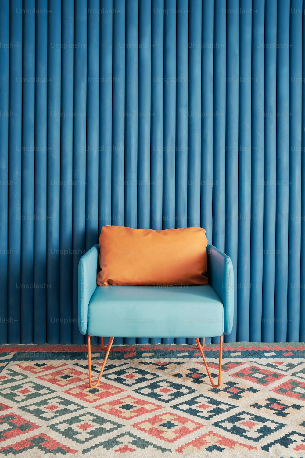 a blue couch sitting in front of a blue wall