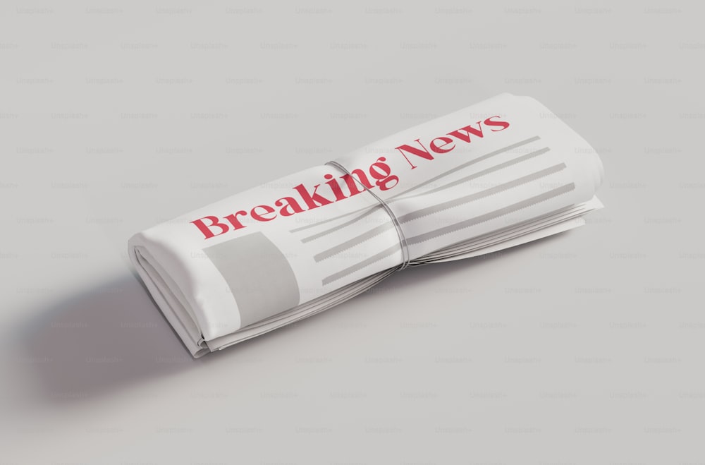 a folded newspaper with the words breaking news on it