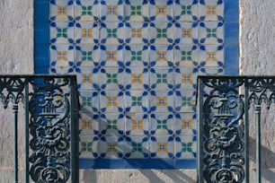 a close up of a metal fence near a building