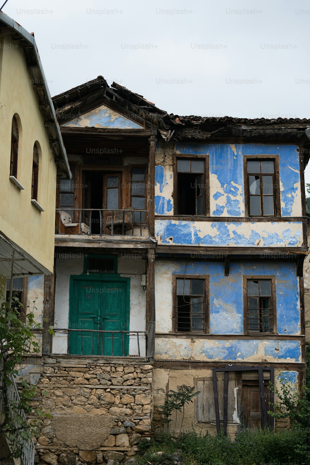 a blue and white building with a green door