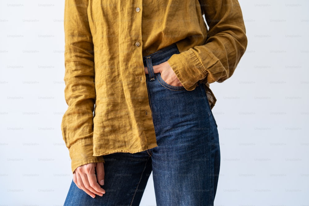 a woman wearing a yellow shirt and jeans