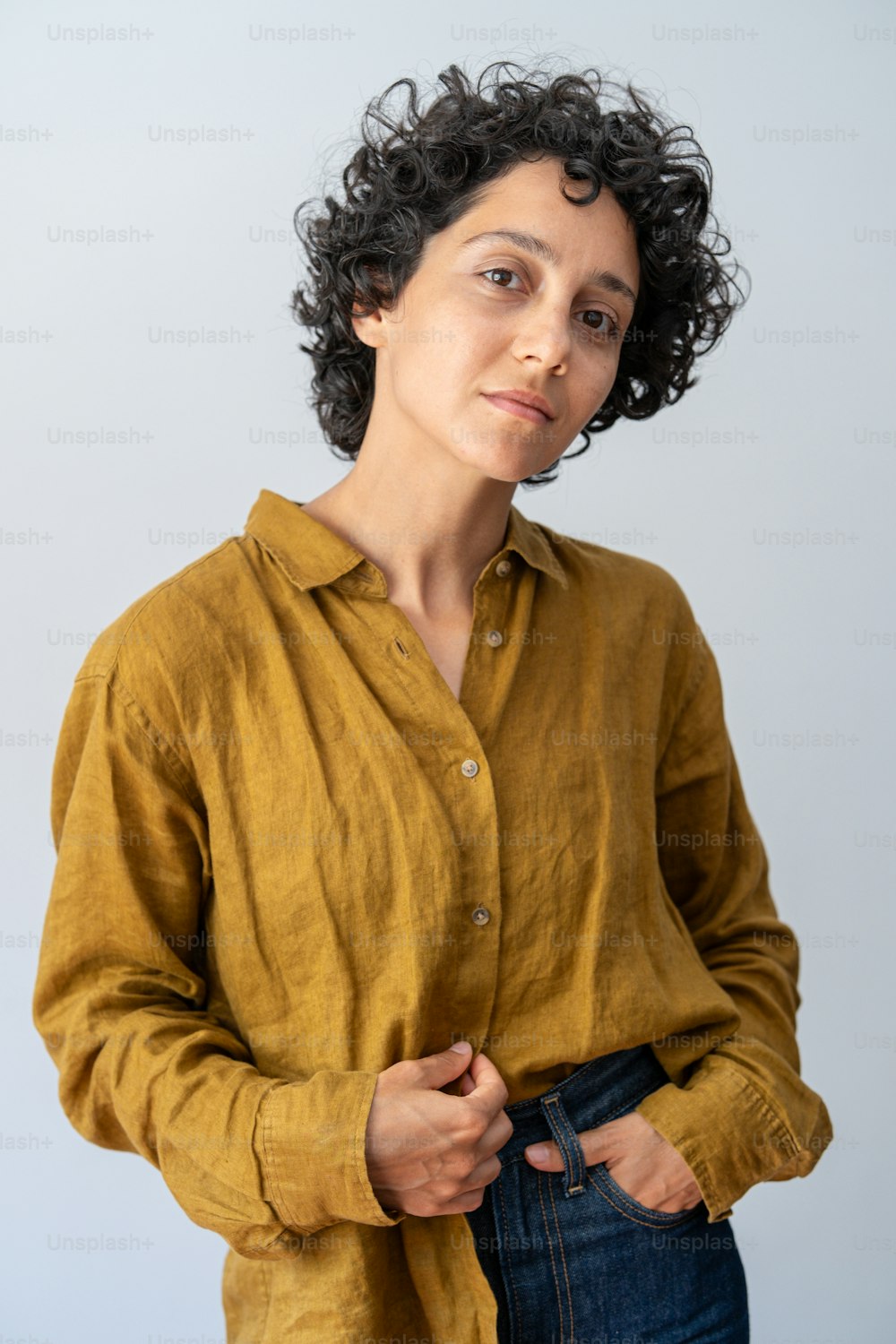 a woman in a yellow shirt is holding her jeans