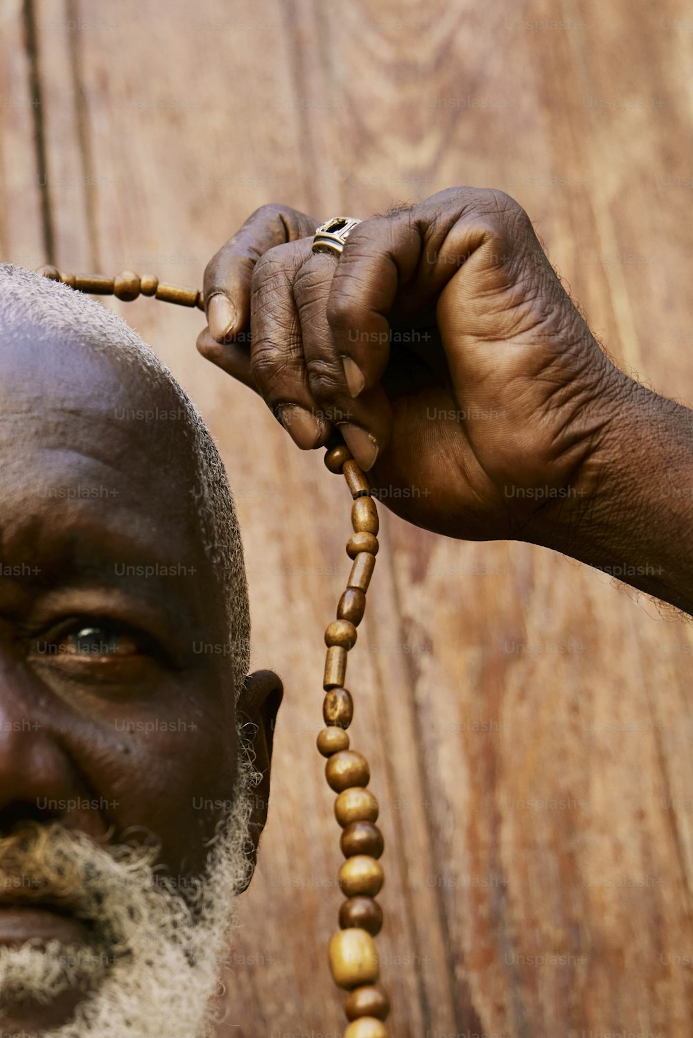 a close up of a person holding a rosary