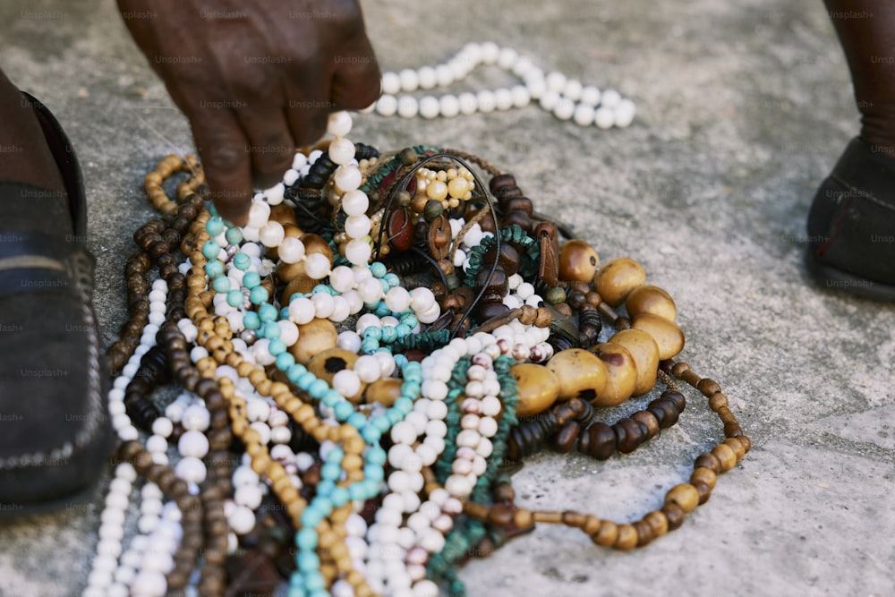 a close up of a person holding beads