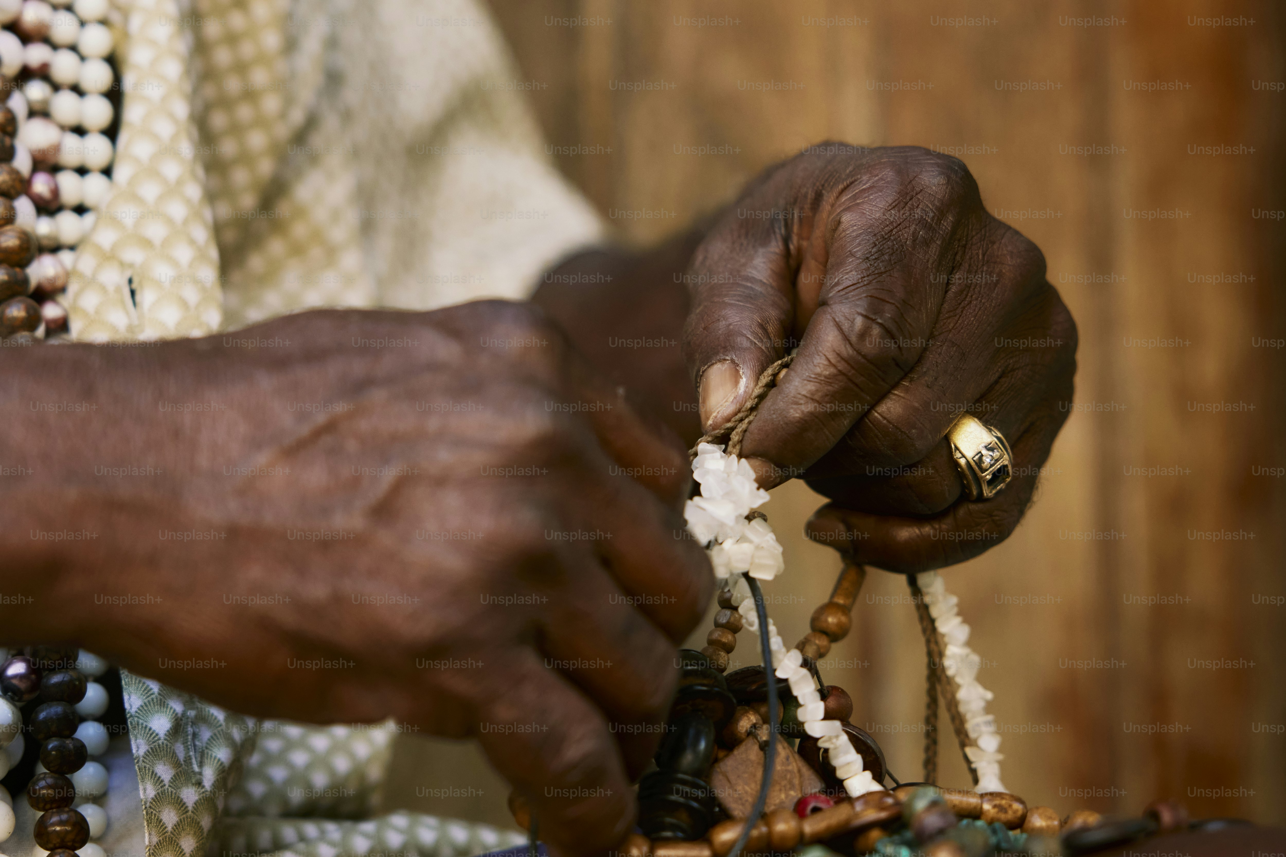 a close up of a person holding a piece of jewelry