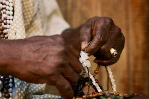 a close up of a person holding a piece of jewelry