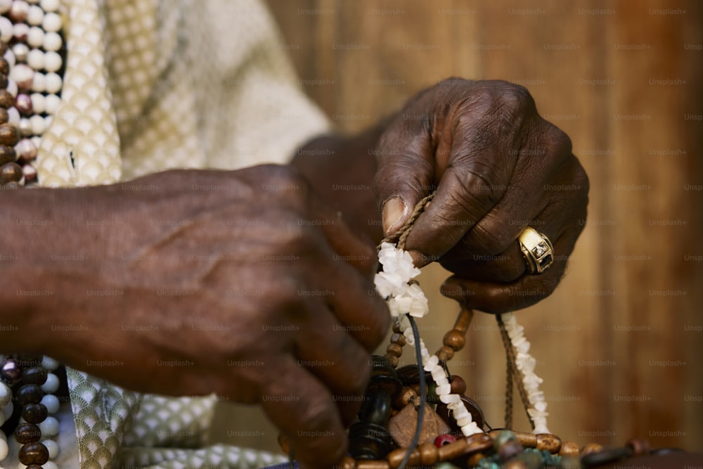 a close up of a person holding a piece of jewelry