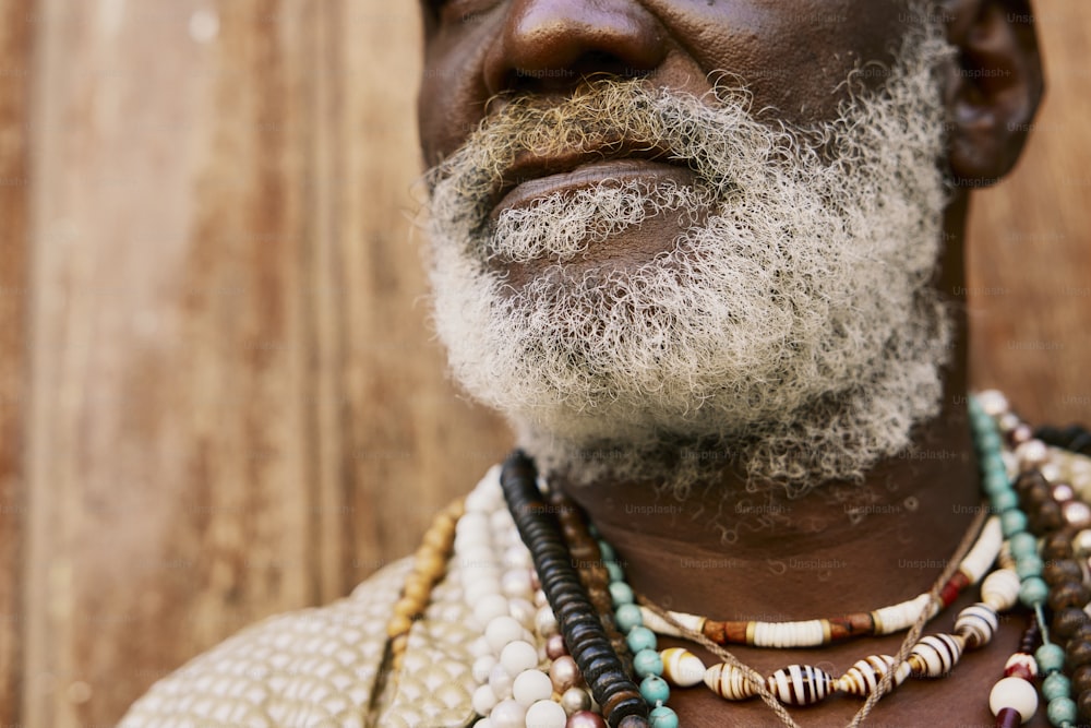 a man with a white beard wearing a necklace