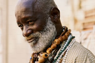 a man with a white beard wearing a necklace