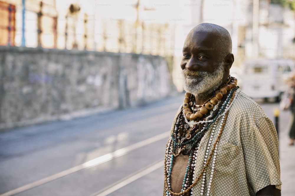 a man with a beard and beads on his neck