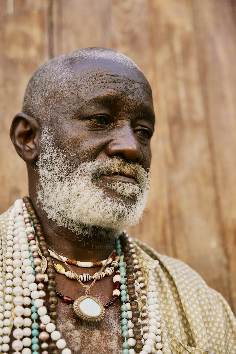 a man with a white beard wearing beads and a necklace