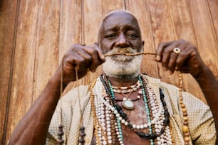a man with beads and a necklace on his neck