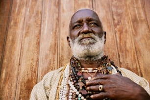 a man with a white beard wearing a necklace