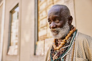 a man with a white beard wearing a necklace