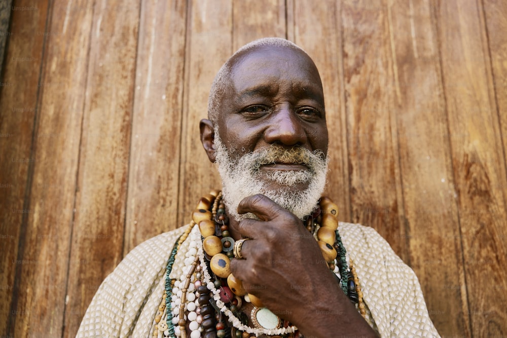 a man with a white beard wearing a beaded necklace