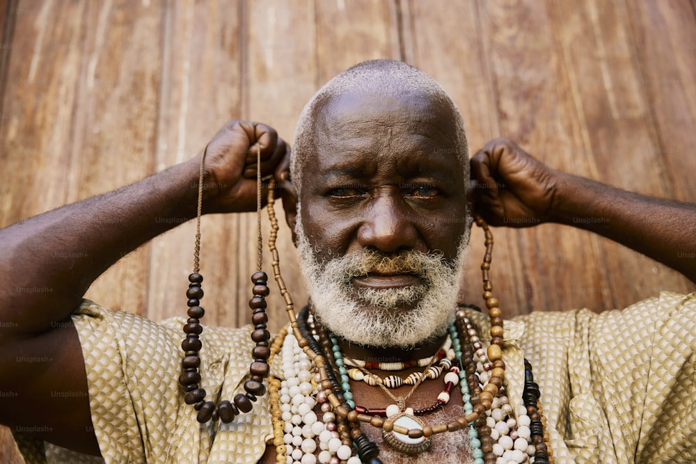 a man with a beard and necklaces on his neck