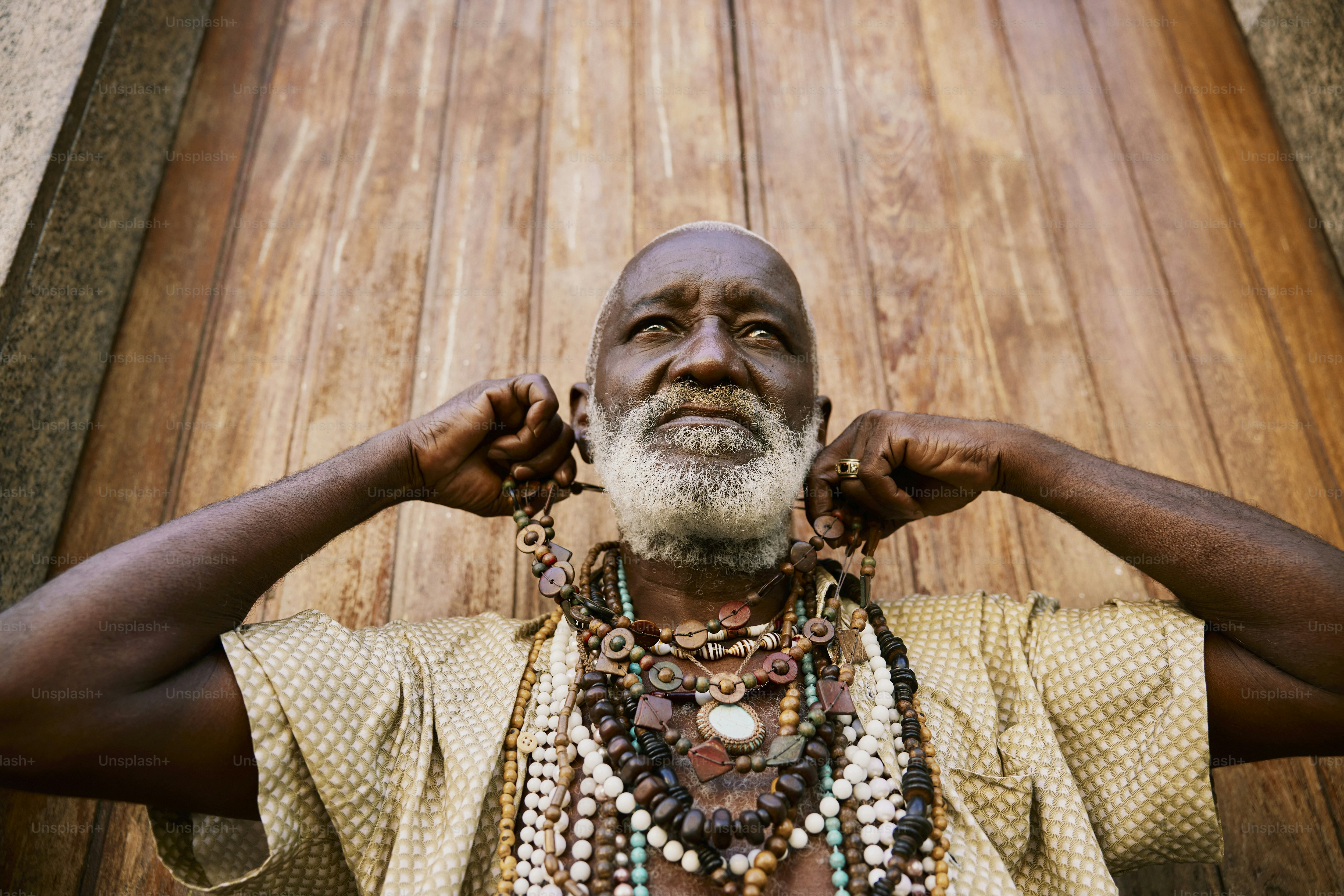a man with a white beard wearing a necklace