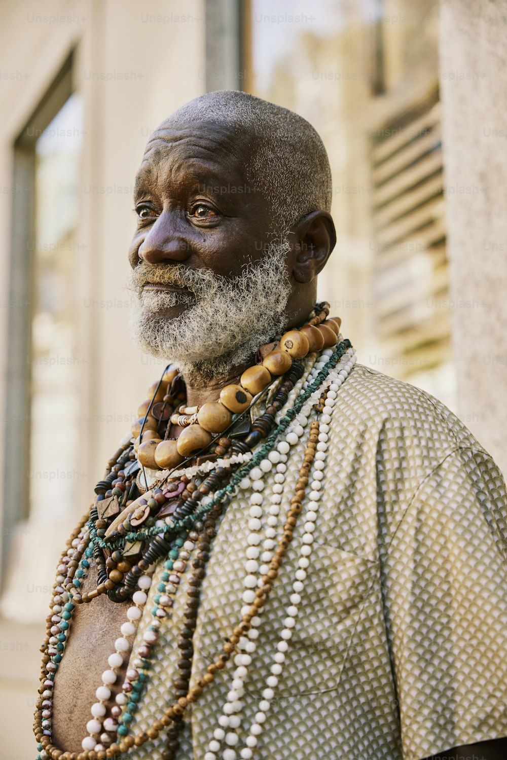 a man with a beard wearing beads and a necklace