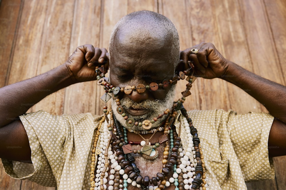 Un uomo con un sacco di perline intorno al collo