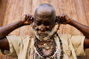 a man with a lot of beads around his neck