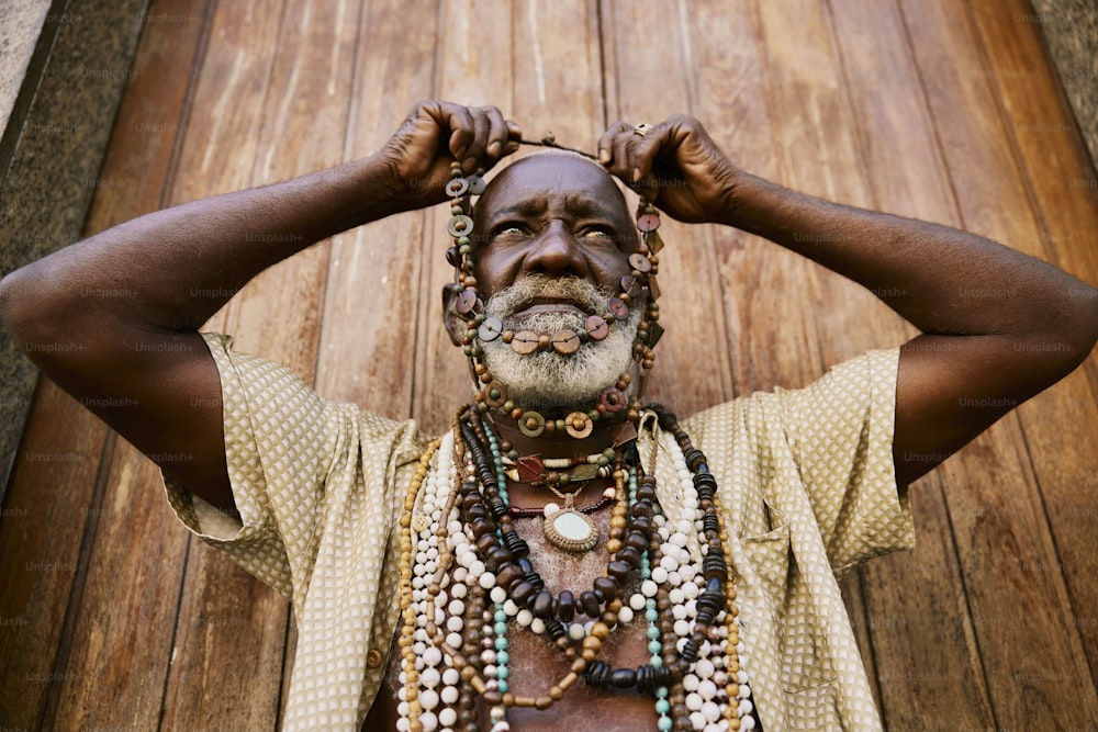 a man with a beard and beads around his neck