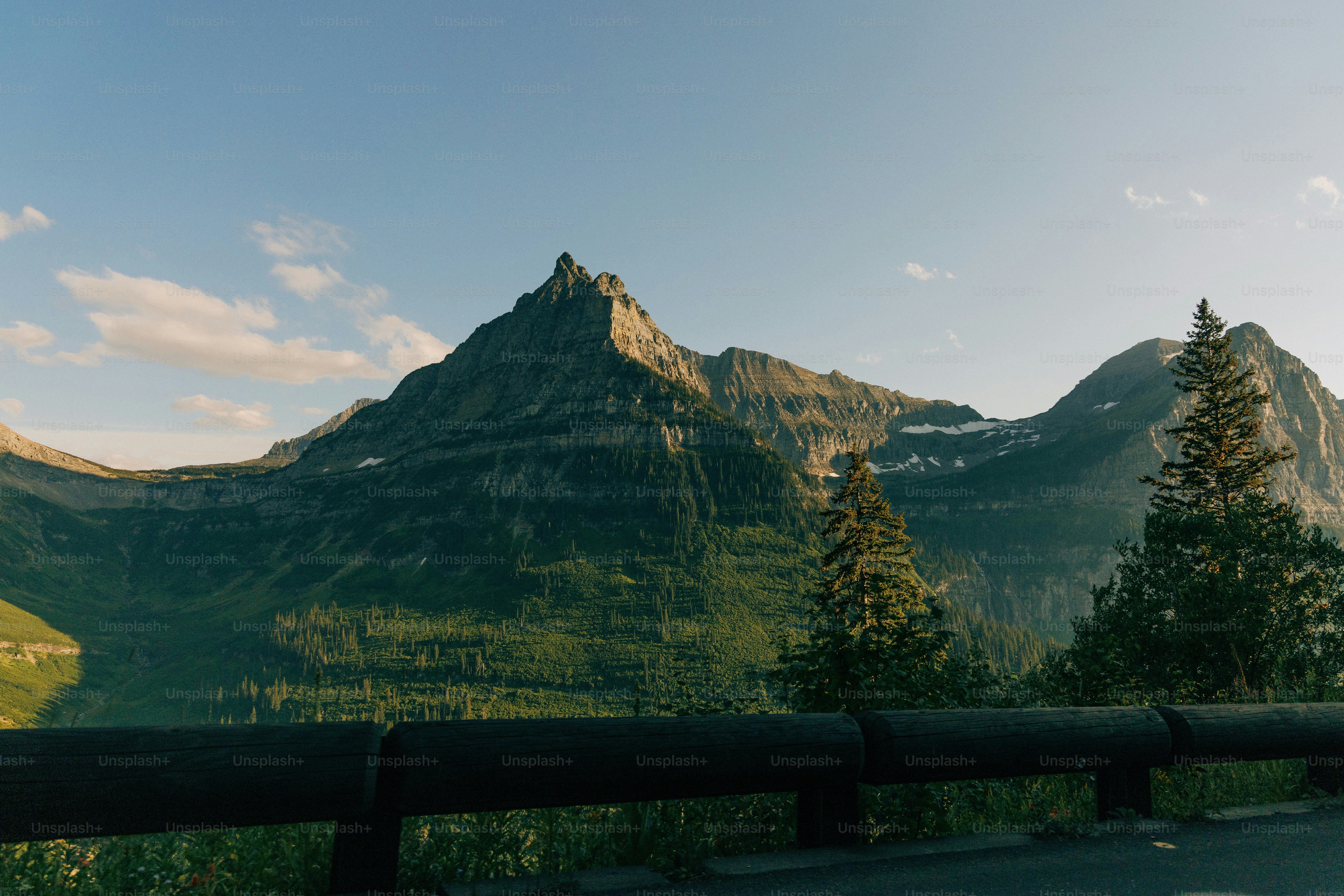 a scenic view of a mountain range with trees and mountains in the background