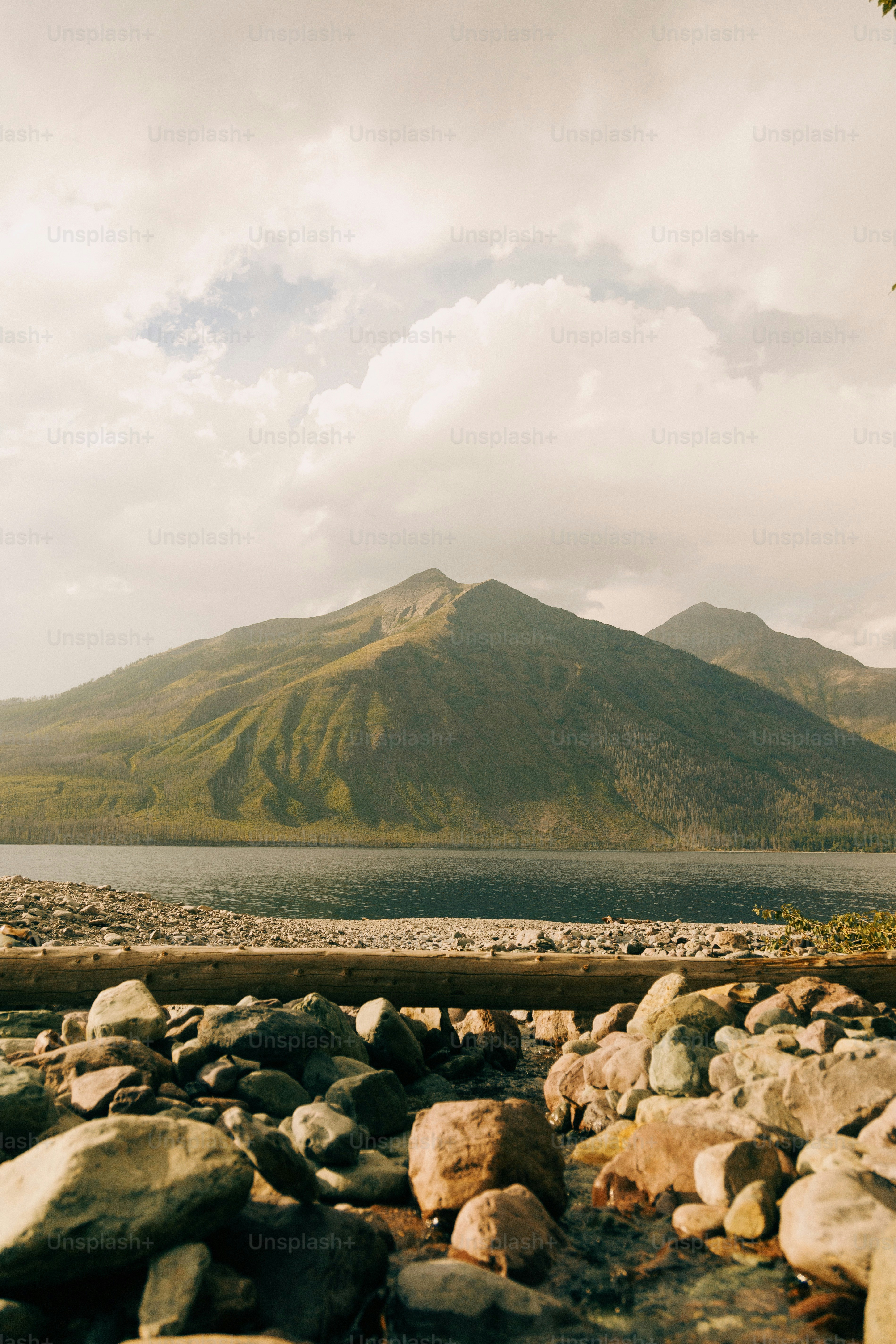 a mountain range with a body of water in the foreground