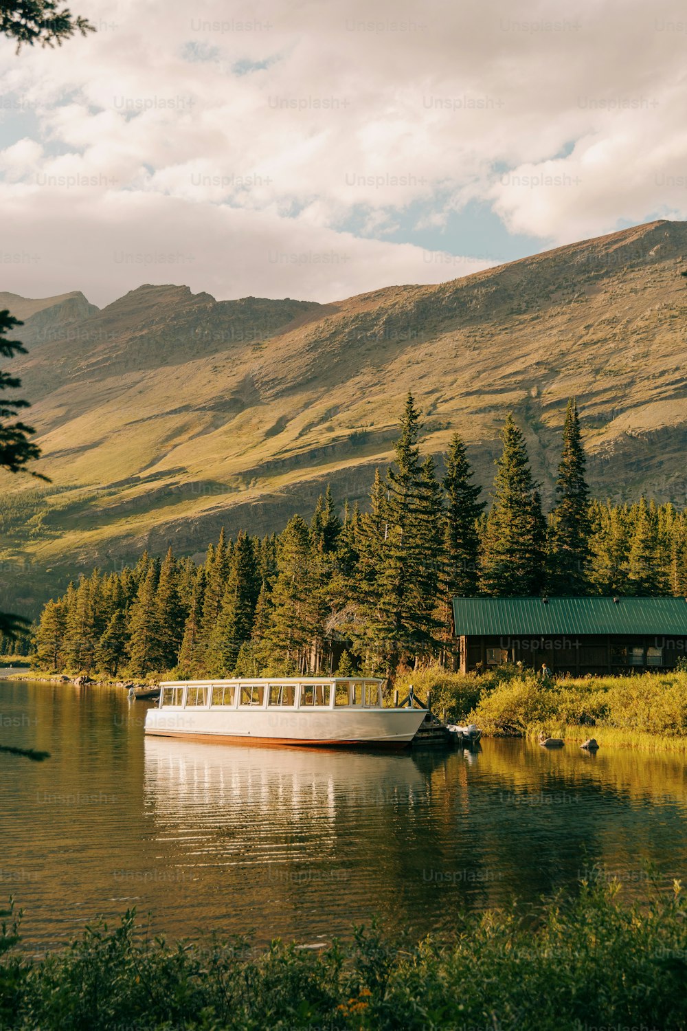 a boat on a lake in front of a mountain