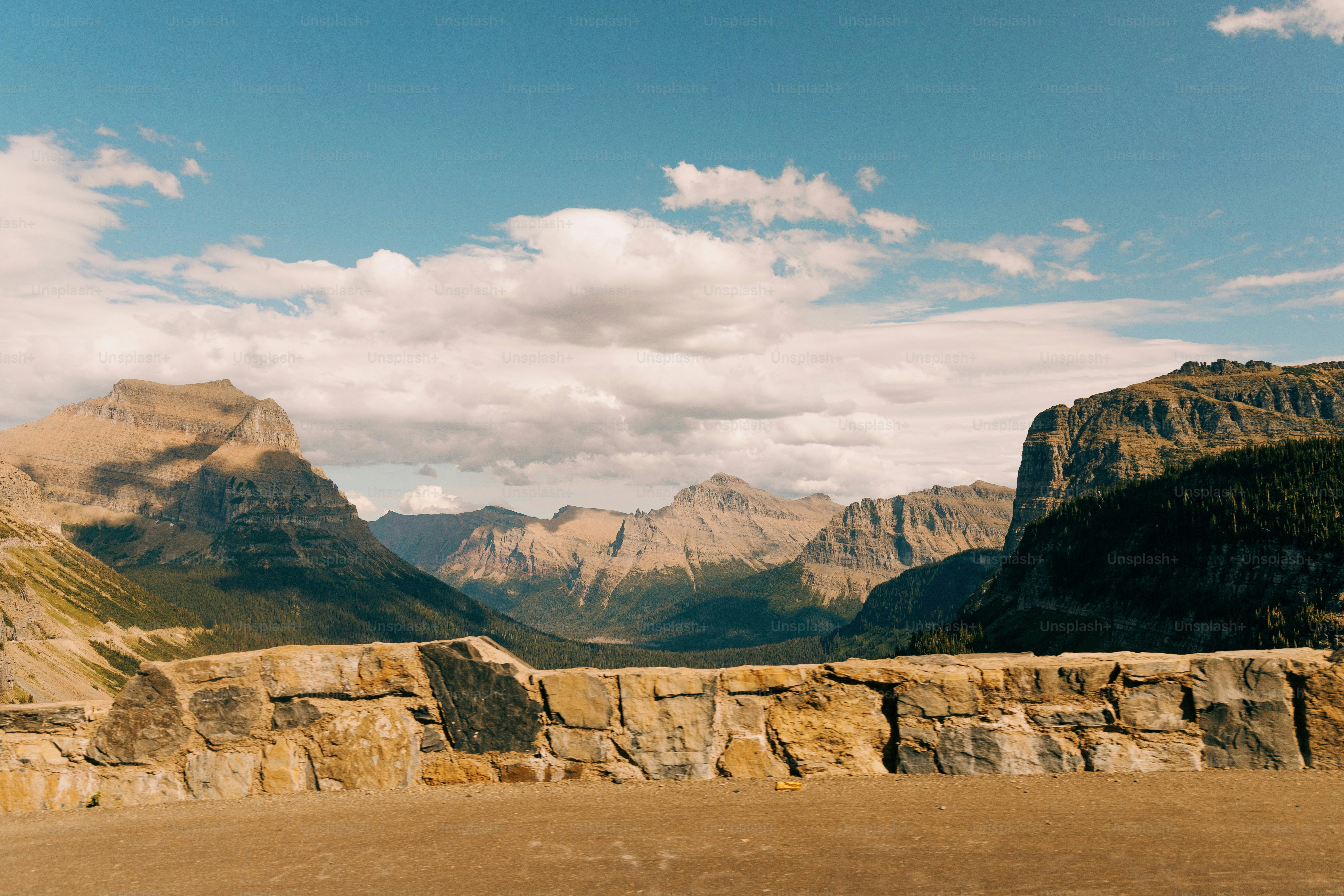 a view of a mountain range from the top of a hill