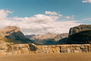 a view of a mountain range from the top of a hill