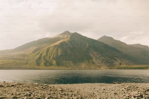 a large body of water with a mountain in the background