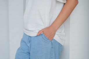 a woman wearing a white shirt and blue jeans
